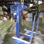 Knez forklift attachment hanging in a warehouse
